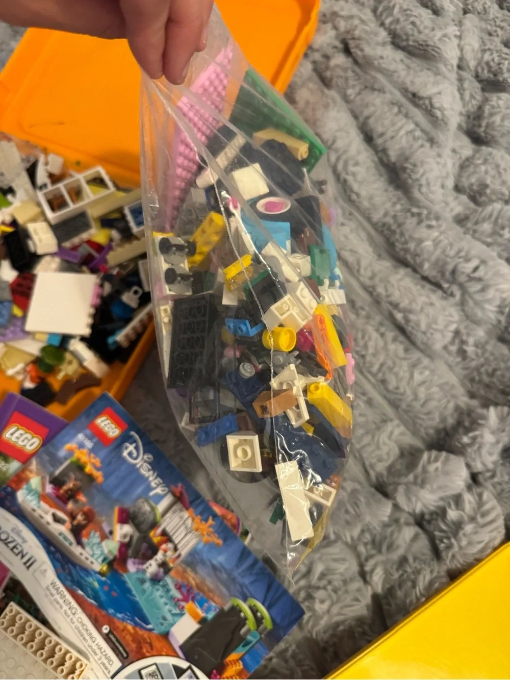 Lego Yellow and Orange Carry Cases filled with Lego bricks and a bag of boards